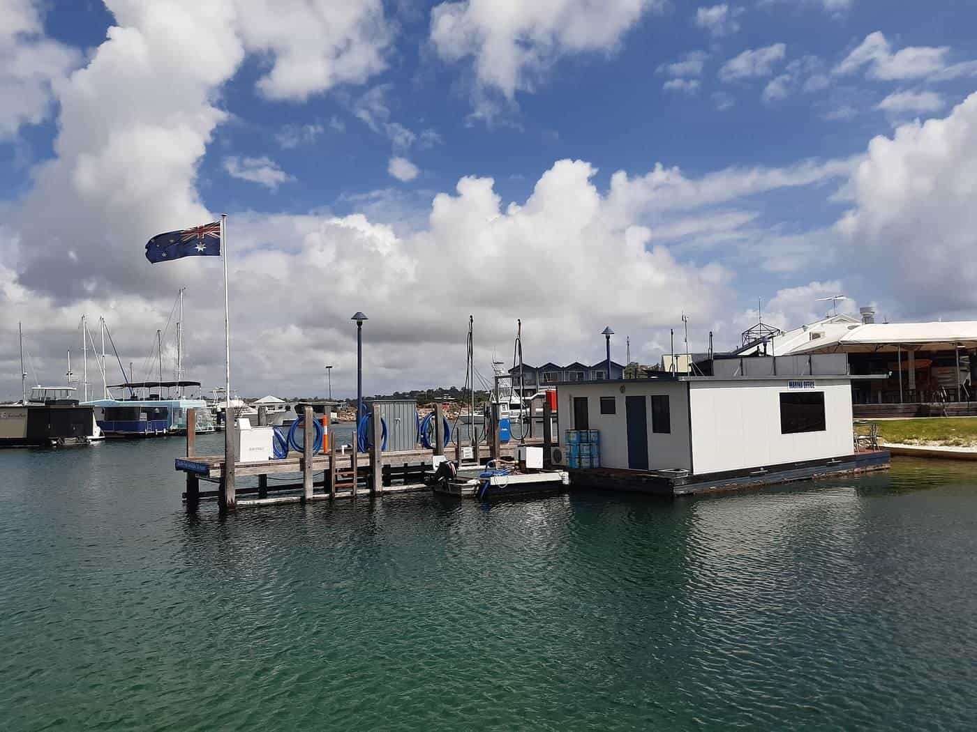 A fuel jetty with pumps at the end of a marina pontoon